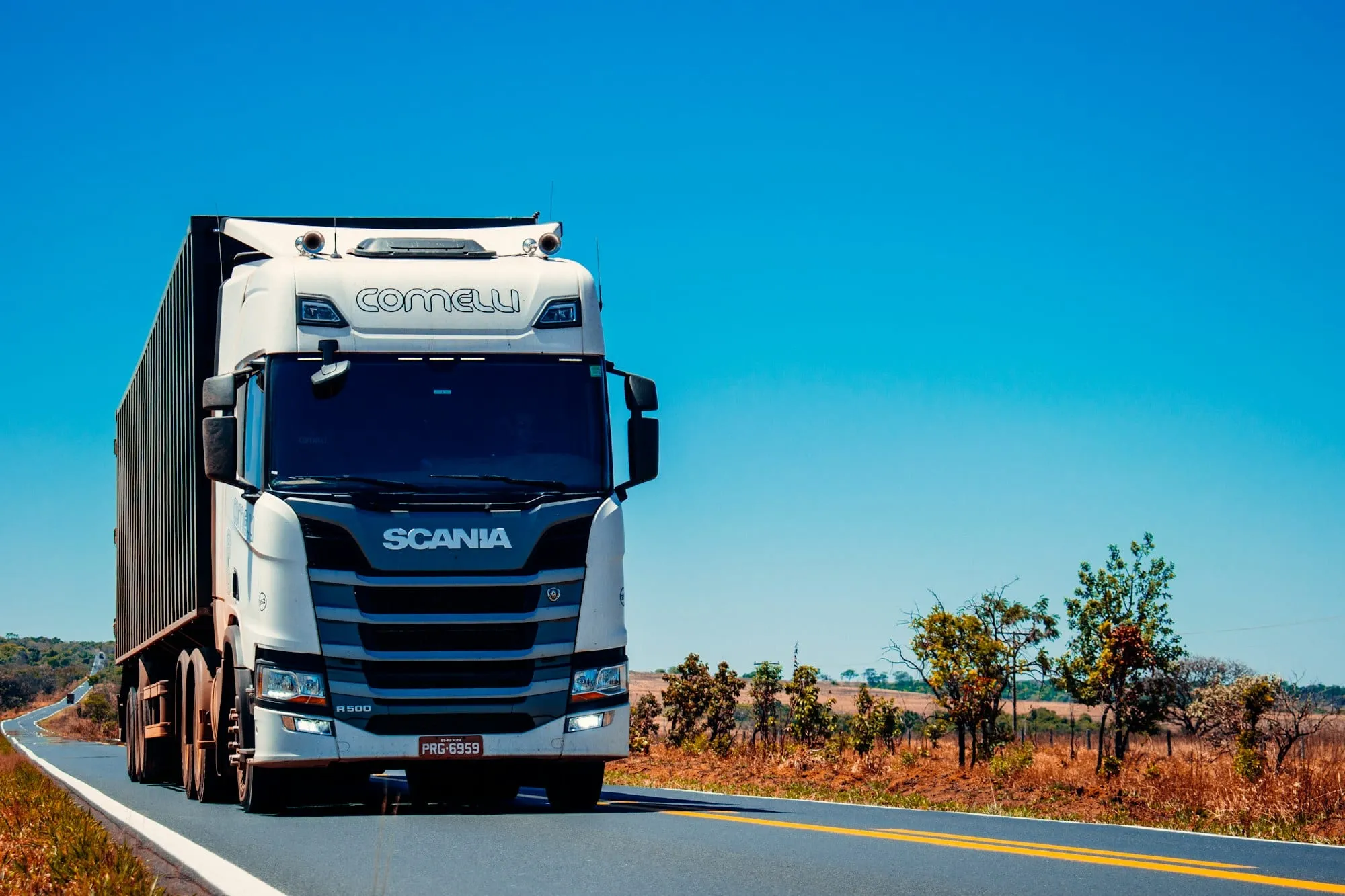 White Scania truck on a highway