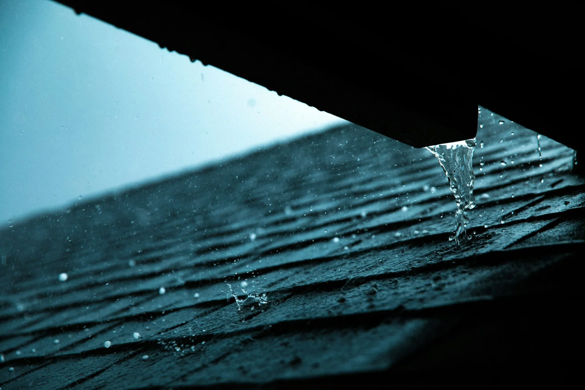 Rainwater running off the edge of a roof